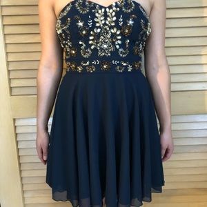 Navy blue beaded dress; strapless.